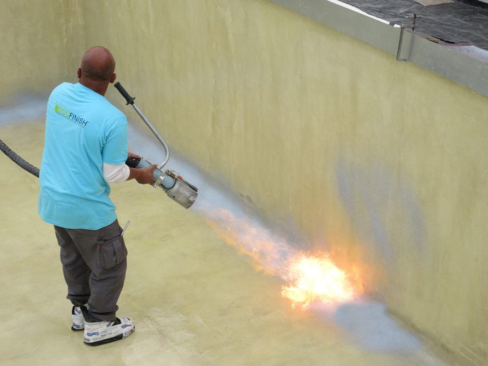 Somebody is using a flamethrower to apply a swimming pool finish.