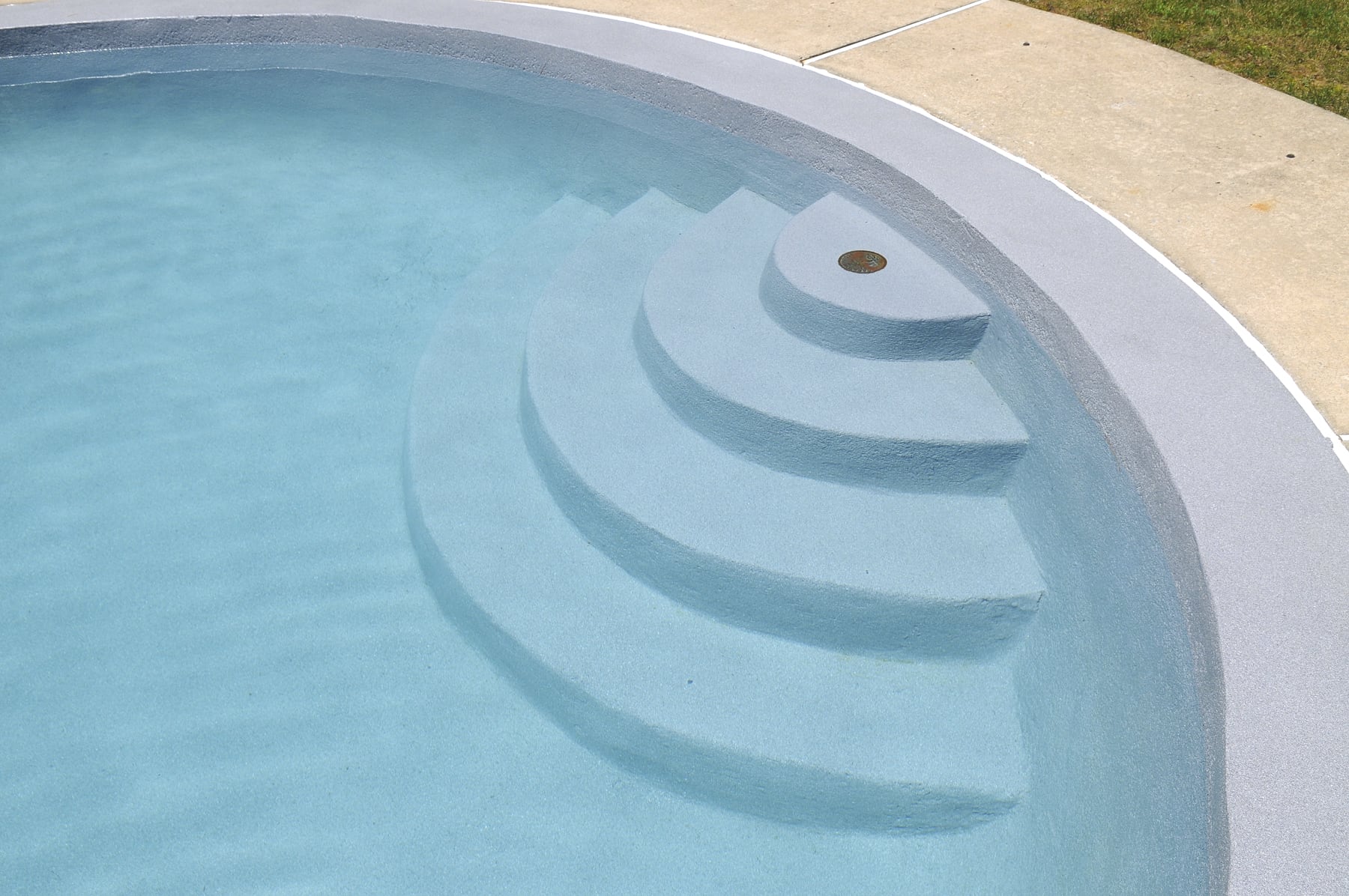 Pool steps featuring a grey reef pool finish.