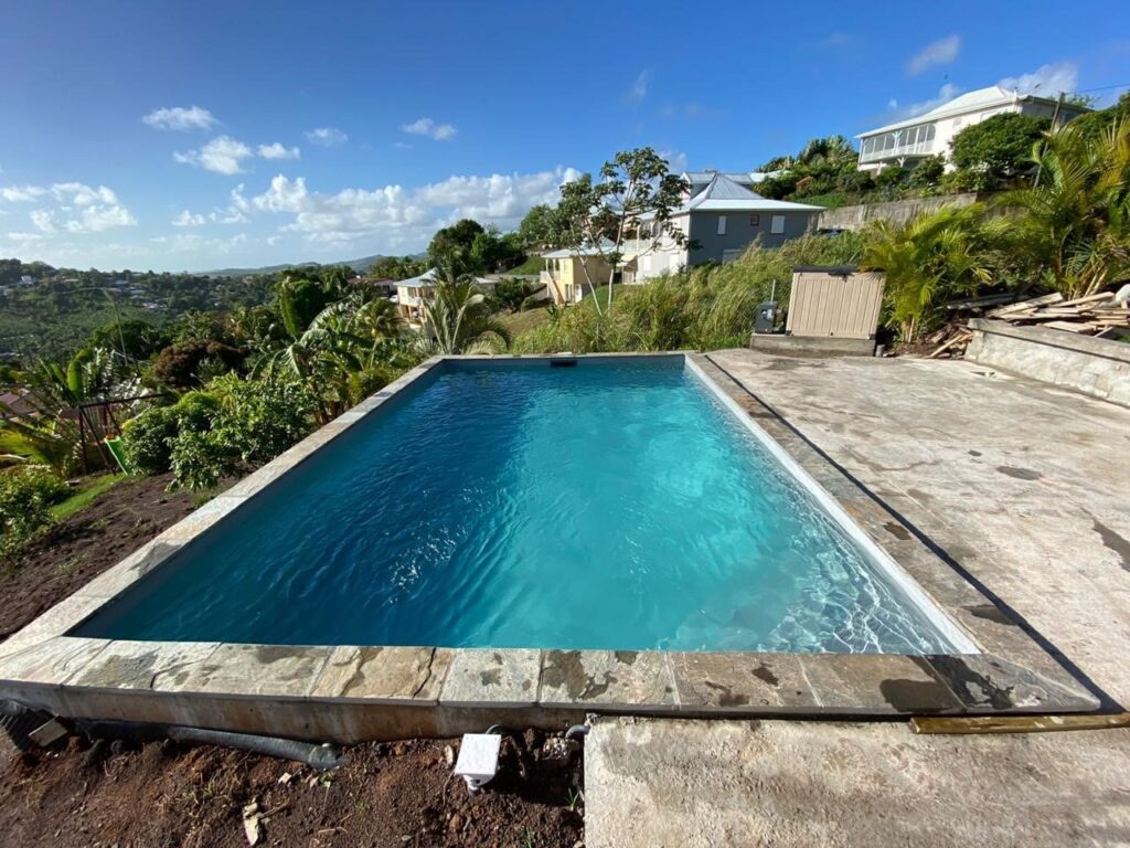 A rectangular in-ground pool with a Kona Coast cover.