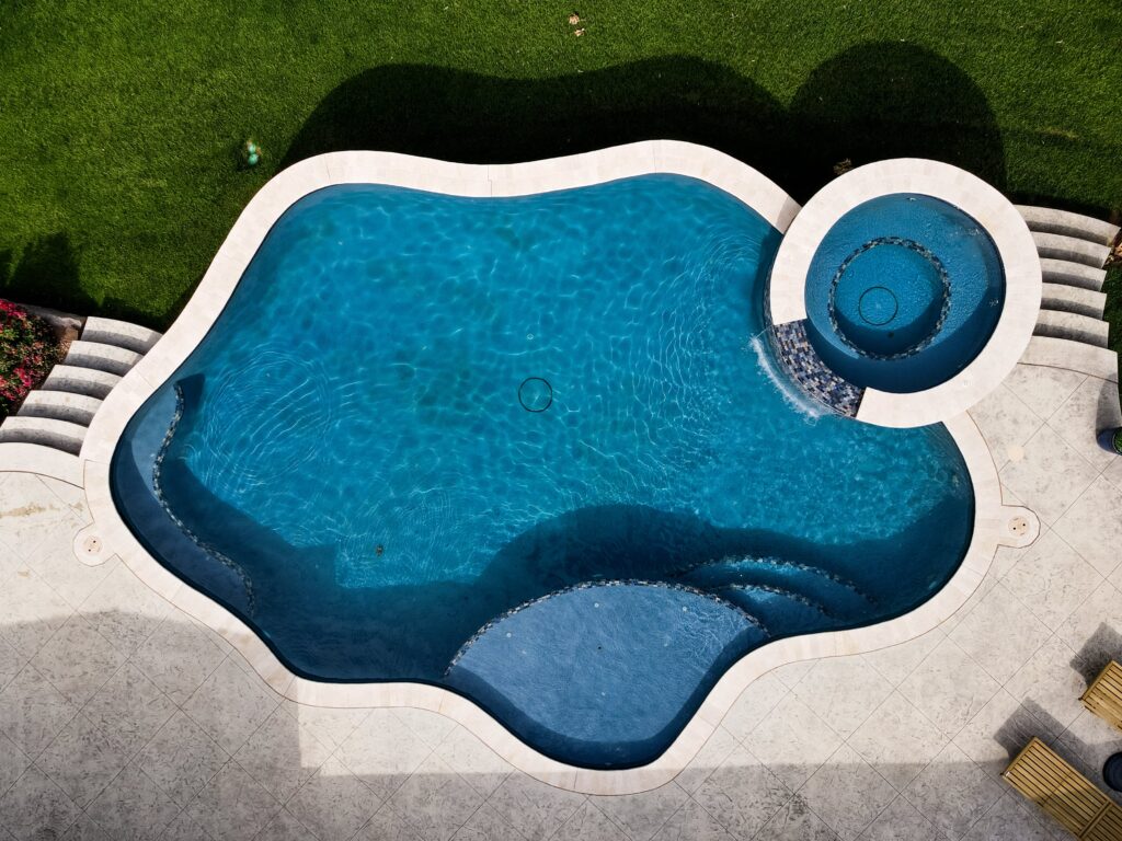 Bird's-eye view of a stunning free-form inground pool in a backyard.