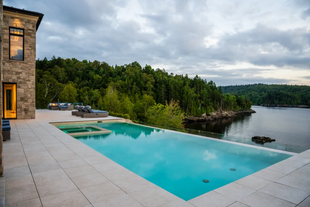 inground swimming pool with a sandy beach aquabright coating