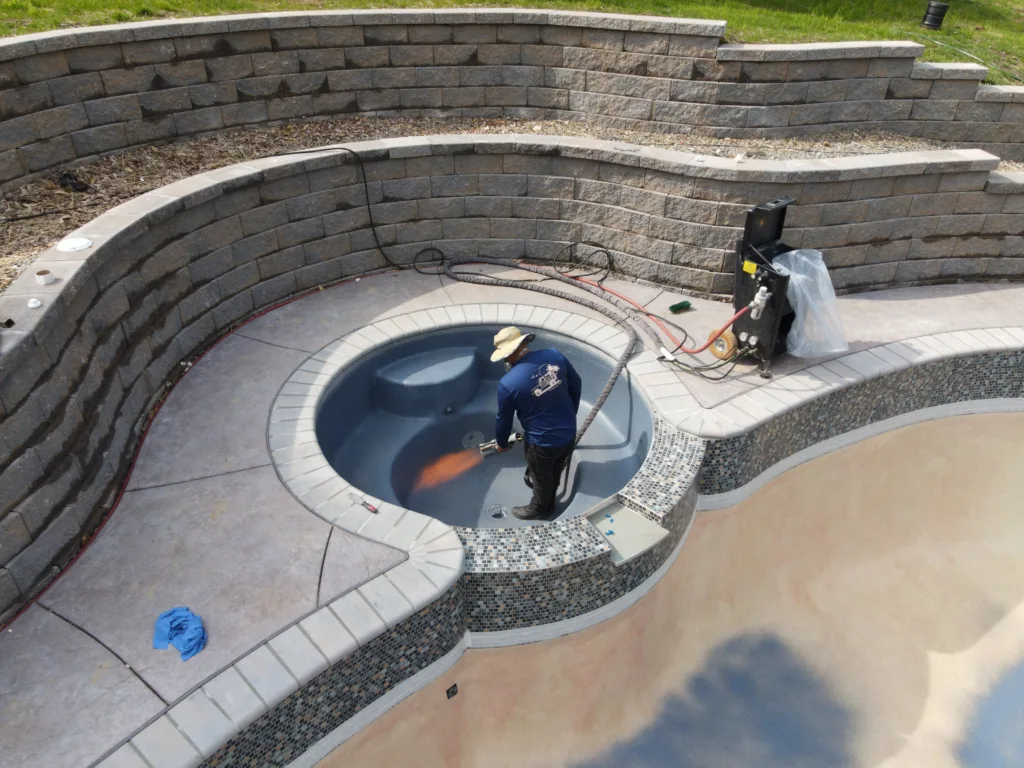 men applying an ecofinish coating to a spa