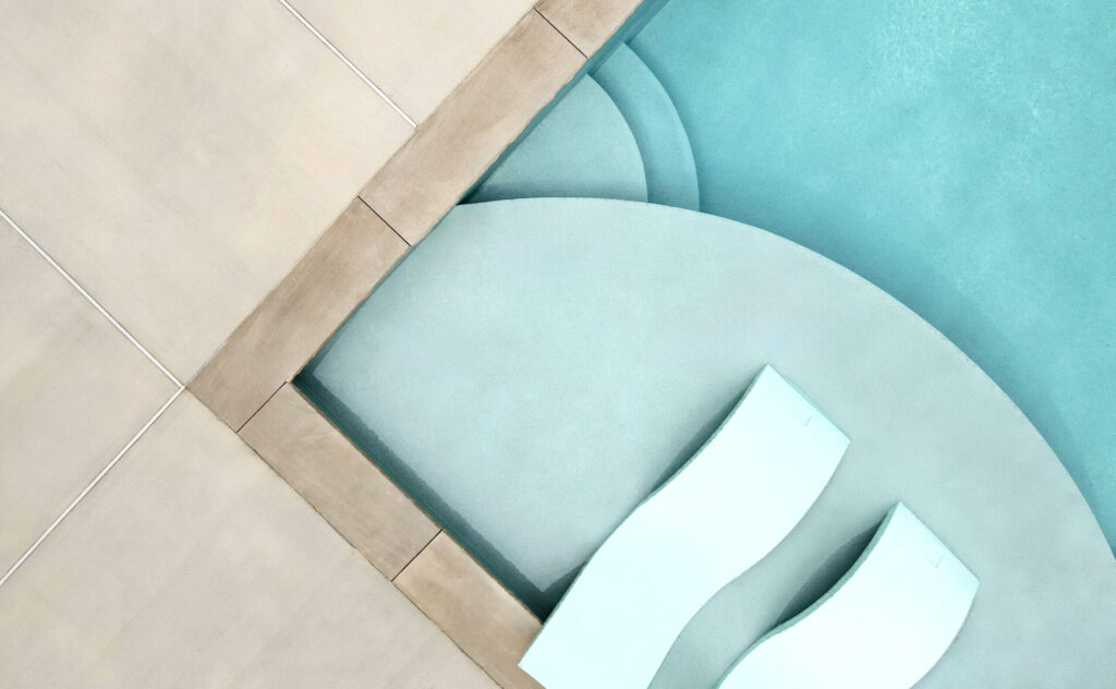 a birds-eye-view of an inground pool's sunshelf with a markaesh colored ecofinish coating